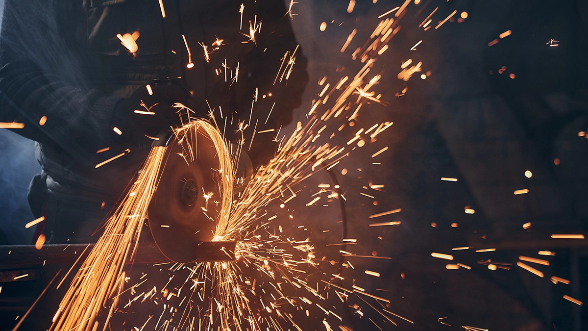 Abrasive machining of metal with a shower of sparks