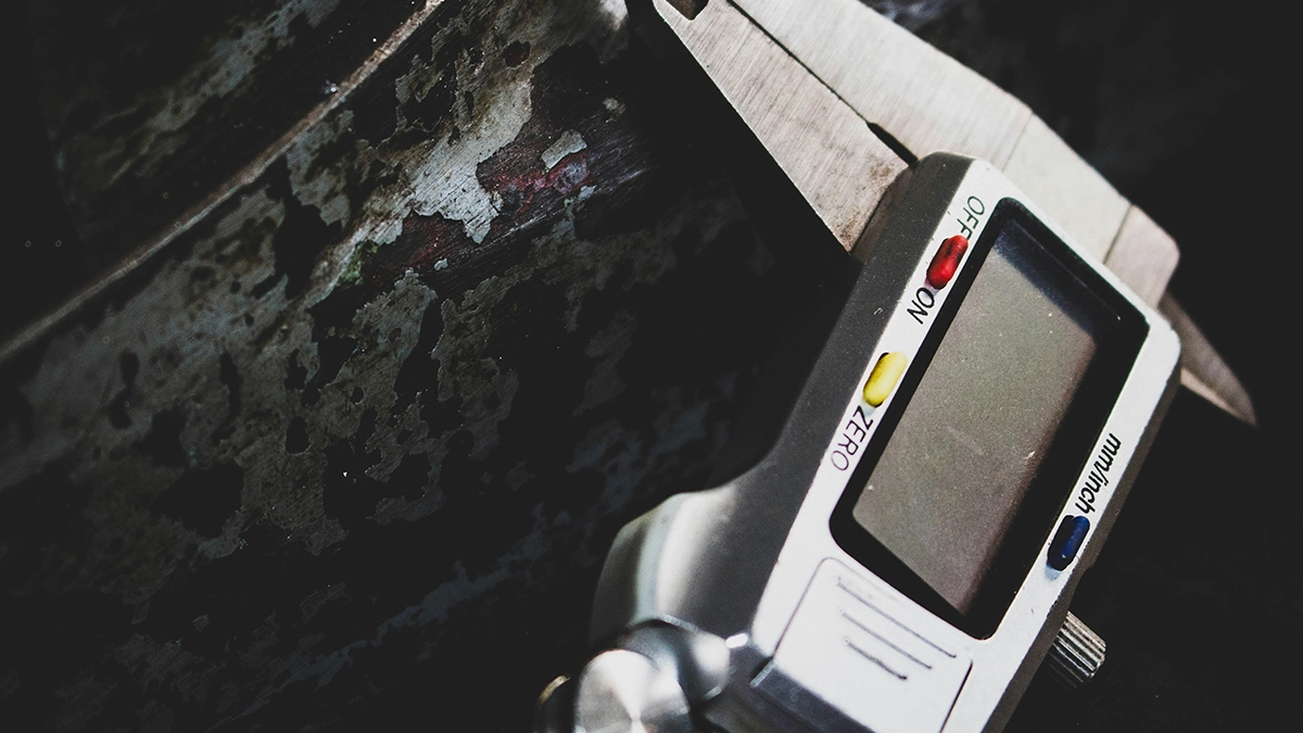 Measuring a part diameter with a digital calliper in the workshop